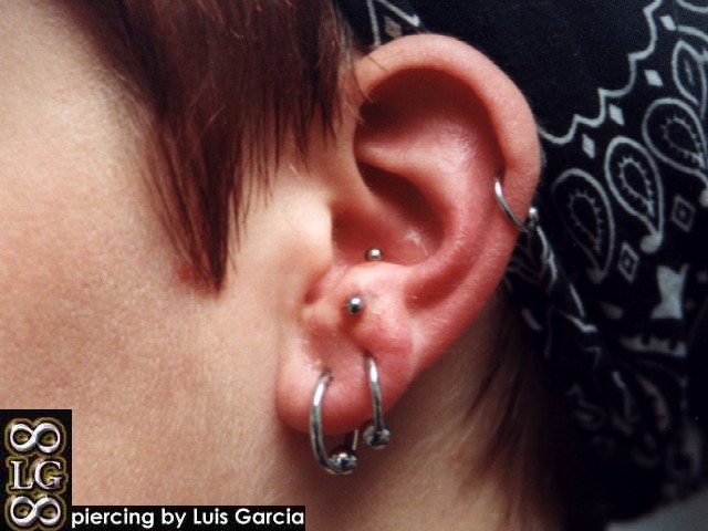 Anti-tragus piercing with 16ga 5/16" steel curved barbell.