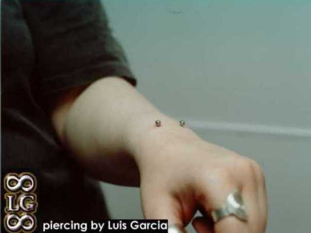 Wrist piercing with a 12ga 3/4" x 1/8" surface barbell.