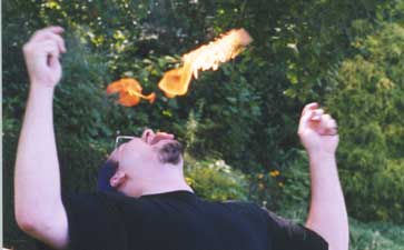 Transfer 1 -- Passing fire from one torch to another using my tongue(which is on fire in the picture although you can't see it).